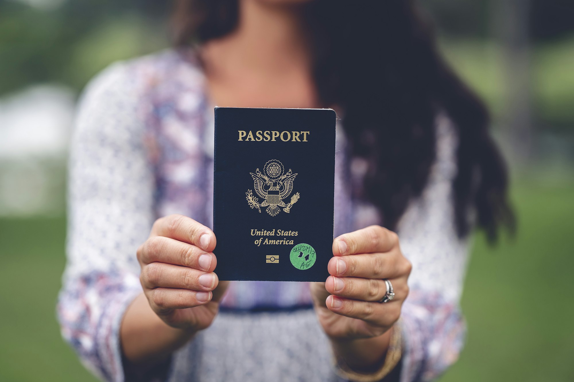 Female showing her passport of the United States of America