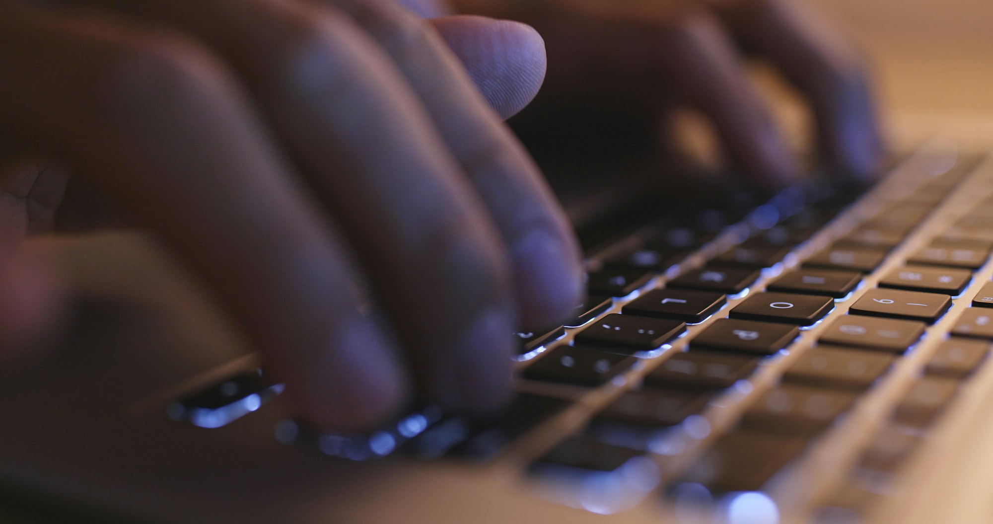 Hands typing on computer keyboard